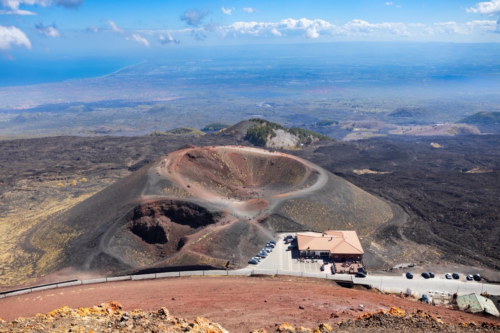 Aerial view of the summit craters of Mount Etna above the Sicilian coast